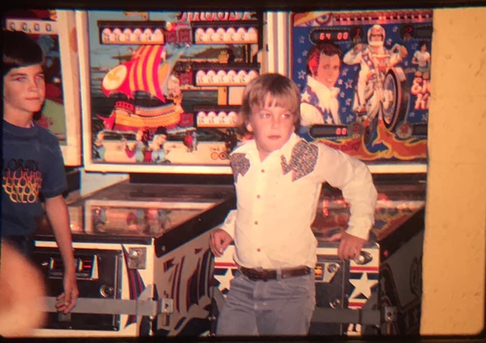 Cooper Olson at a pinball machine